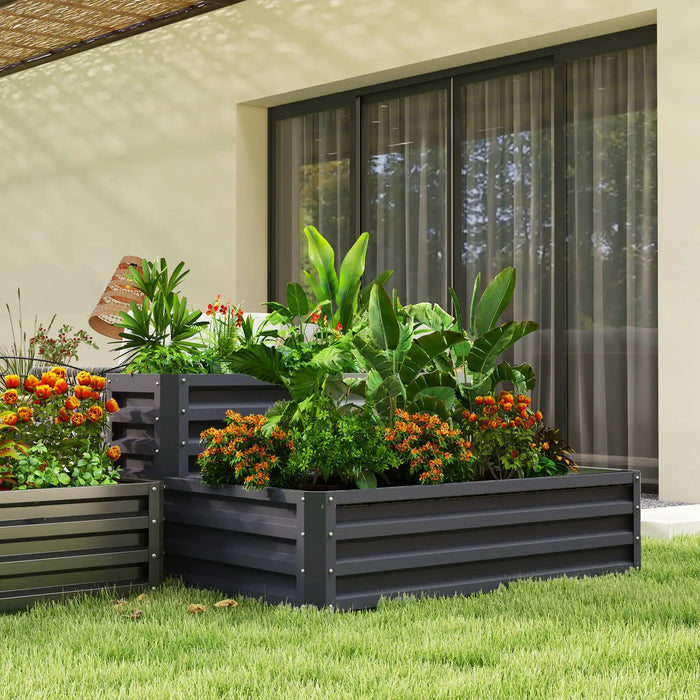 Two-tier galvanized steel raised garden bed with lush tropical and flowering plants in modern backyard