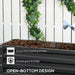 Dark grey two-tier galvanized steel raised garden bed filled with soil being watered, white fence background with green ivy