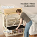 Woman cleaning wooden pet cage with openable top door and pull-out tray for easy maintenance