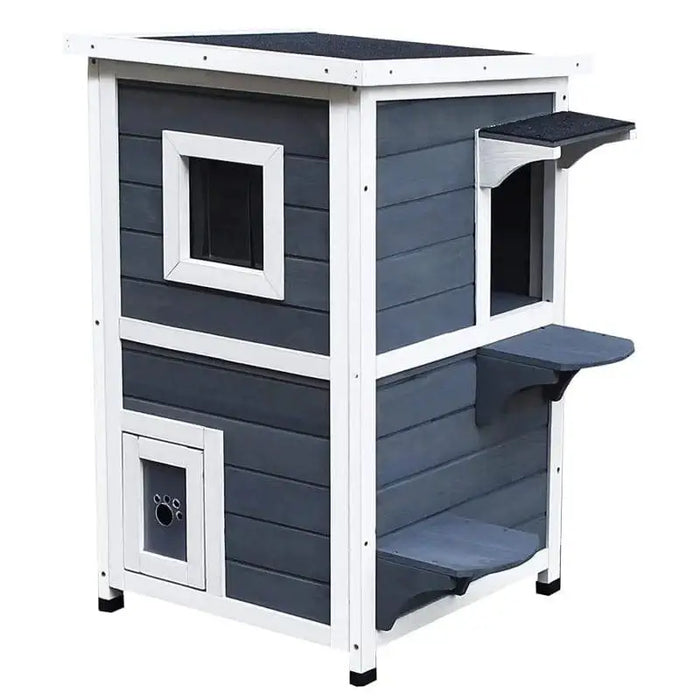 Two-tier grey wooden outdoor cat house with white trim, steps, and paw print door