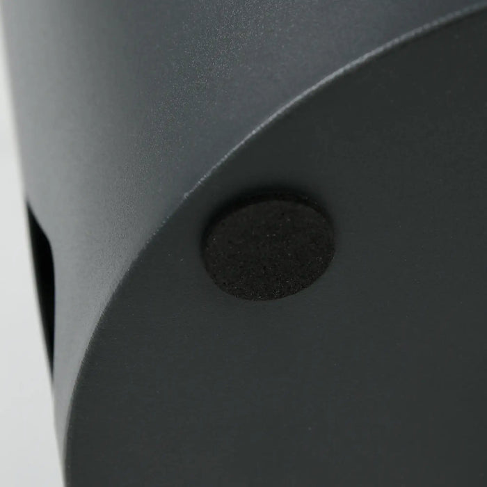 Close-up of a black object with a circular feature on a white background