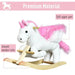 White and pink plush unicorn rocker toy with smooth wooden rails and soft upper seat.