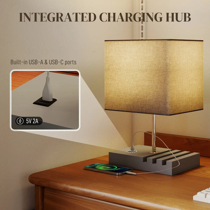 Table lamp with integrated charging hub on a wooden surface, showing USB ports.