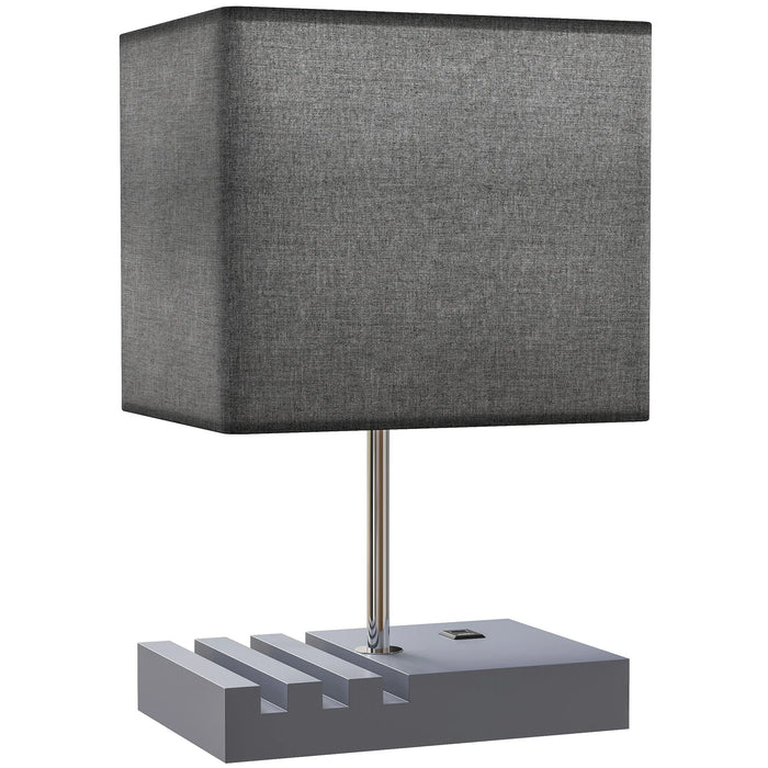 Table lamp with a gray square shade and concrete base on a white background