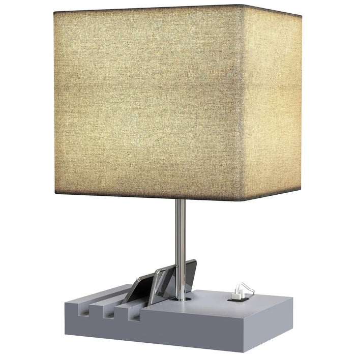 Table lamp with a beige square shade and a gray base on a white background