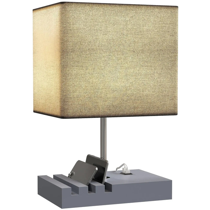 Table lamp with a beige square shade and gray base on a white background