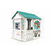 Kids veterinary centre playhouse with teal roof, animal graphics, and white picket fence