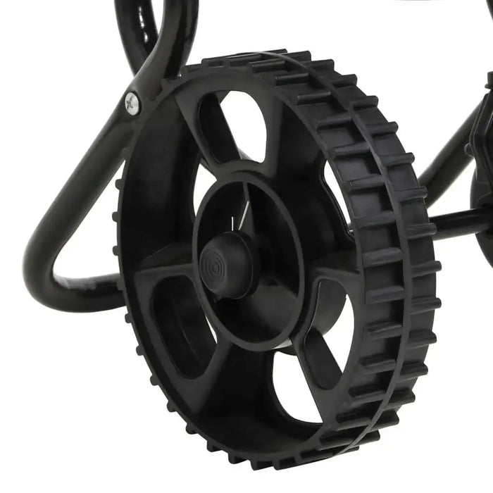Close-up of black plastic wheel on walk-behind salt and fertilizer spreader frame