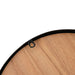 Close-up of rustic wooden wall clock with smooth natural wood grain and black metal frame edge