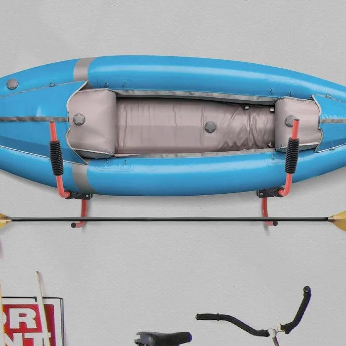 Wall-mounted heavy duty iron kayak rack holding blue kayak with storage hooks