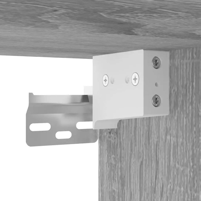 Close-up of white metal wall mount bracket attached to grey wood panel for floating media unit