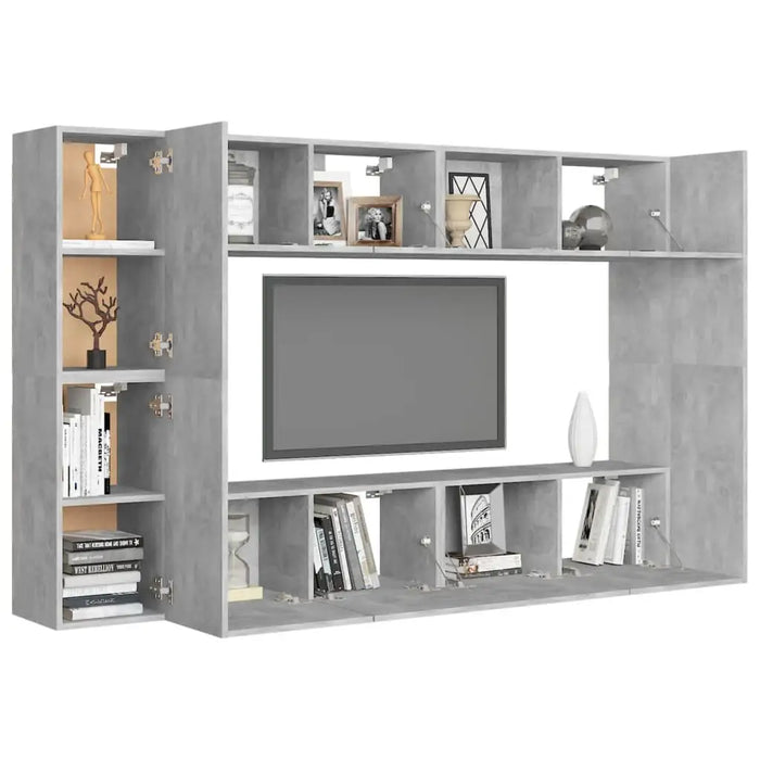Wall-mounted concrete grey TV cabinet with multiple open and closed storage compartments, decorated with books and ornaments