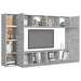 Wall-mounted concrete grey TV cabinet with multiple open and closed storage compartments, decorated with books and ornaments