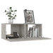 Concrete grey wall-mounted TV cabinet with open compartments, books, decor, and potted plant