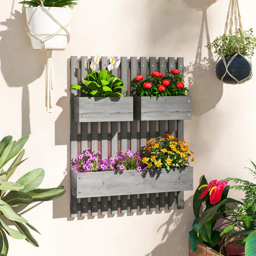 Wall-mounted grey wooden planter with three boxes holding vibrant flowers in bright indoor garden setting
