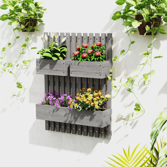 Grey wooden wall-mounted planter with trellis holding green and flowering plants on white wall
