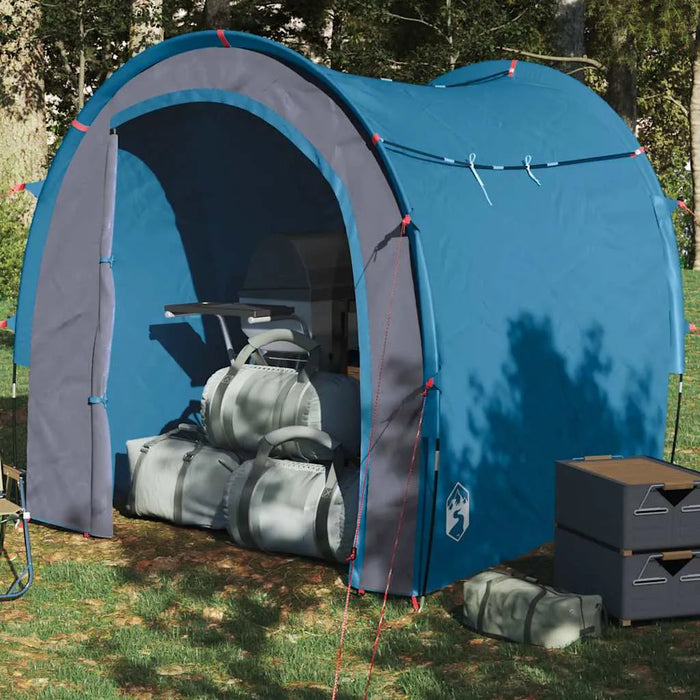 Blue waterproof storage tent for camping with gear bags and organiser in grassy outdoor setting