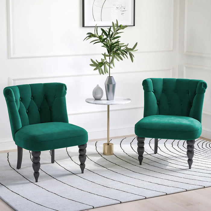 Two green chairs in a room with a small table and plant.
