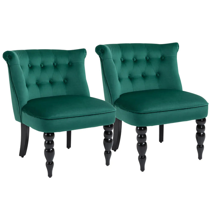Two green velvet chairs with black legs on a white background