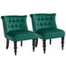 Two green velvet chairs with black legs on a white background