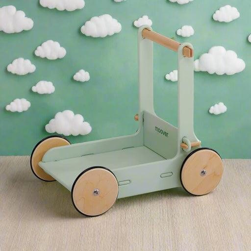 Eco-friendly wooden baby walker in pastel green with natural wheels on wood surface