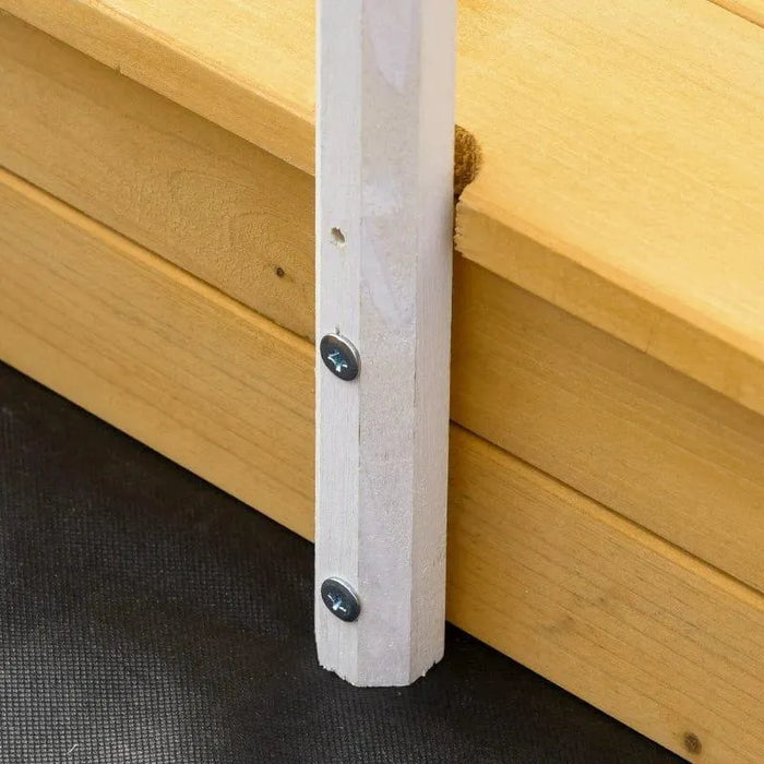 Close-up of wooden sandbox bench corner with screws and base detail