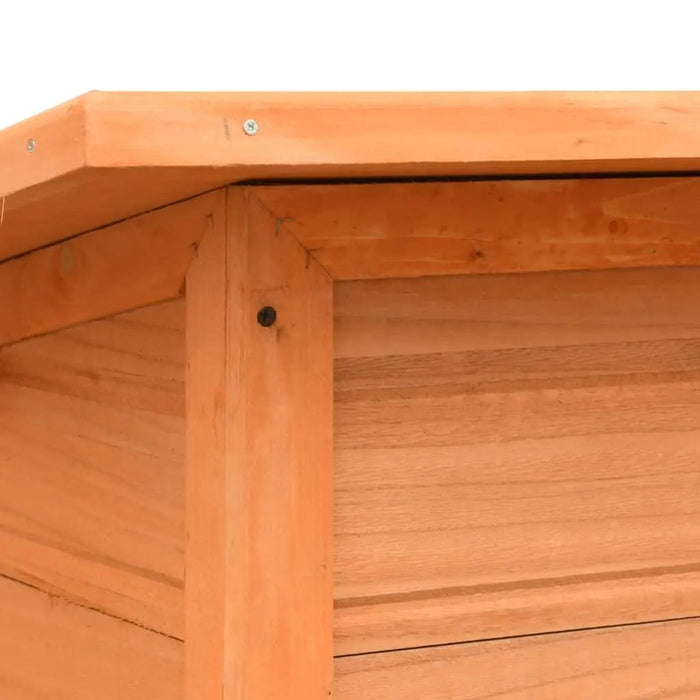 Close-up of outdoor pine and fir wooden dog house with water-resistant roof