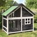 Wooden dog kennel with green water-resistant roof, grey-white frame, and pine wood panels outdoors