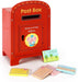 Red toy post box with a cartoon elephant and stationery items on a white background
