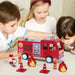 Children playing with wooden fire engine truck playset, firefighter figurines, ladder, and cones.