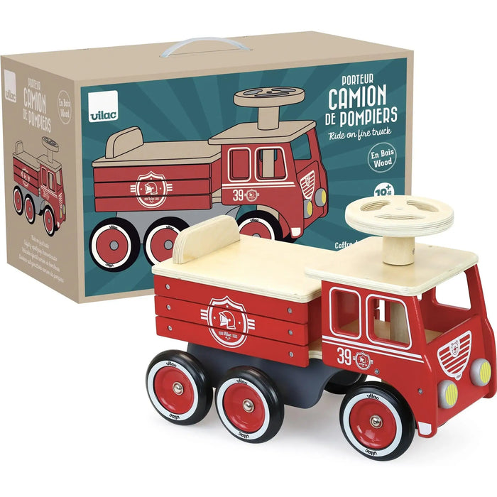 Wooden ride-on fire truck toy with red wheels shown in front of Vilac branded box