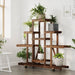 Wooden flower stand with wheels displaying potted plants in a bright living room