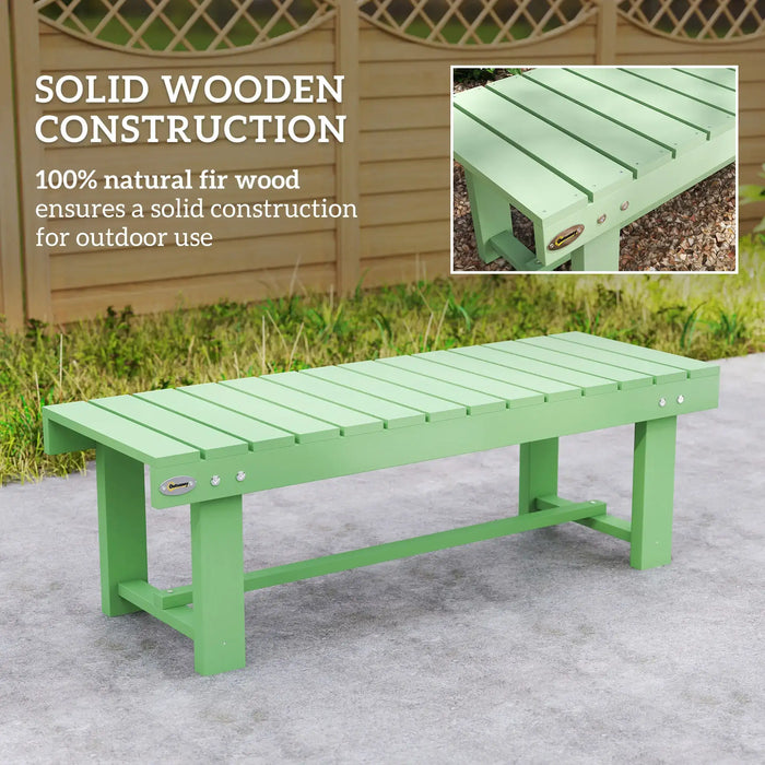 Light green solid fir wood outdoor garden bench on concrete patio with wooden fence backdrop