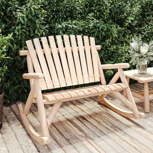 Natural spruce wood Adirondack-style garden rocking bench on wooden deck with green hedge background