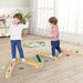 Kids playing on wooden Montessori balance beam set with stepping stones indoors
