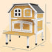Yellow two-tier wooden outdoor cat house with terrace, windows, and platform, shown with measurements.