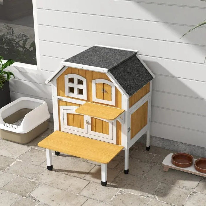 Yellow wooden outdoor cat house with terrace and jump platform on patio