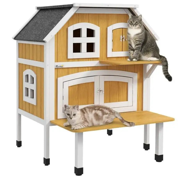 Two cats on yellow wooden outdoor cat house with terrace and white trim