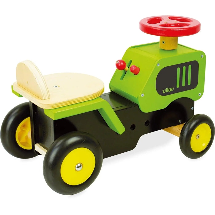 Wooden ride-on tractor toy with green and black body, red steering wheel, Vilac brand