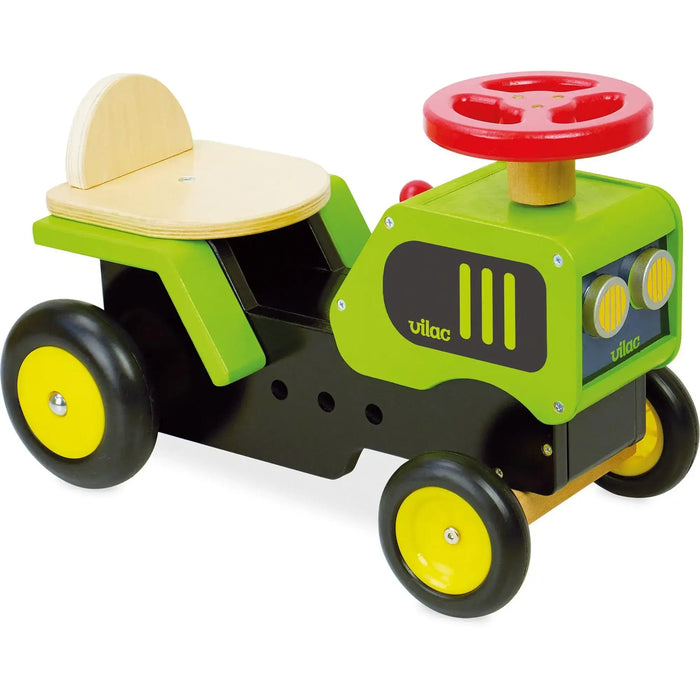 Wooden ride-on tractor toy with a red steering wheel, green and yellow Vilac design