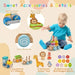 Toddler playing with wooden stackable train set, animal figures and colorful blocks.