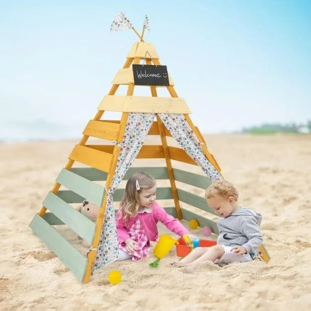 Kids playing in a wooden Montessori teepee tent on a sandy beach with toys.