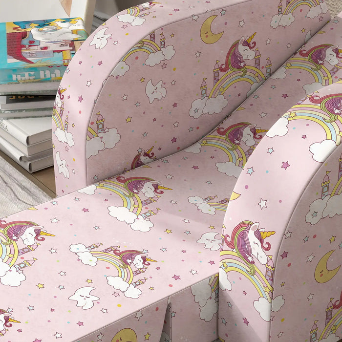 Pink children's armchair with unicorn, rainbow, cloud, star, moon, and castle pattern upholstery
