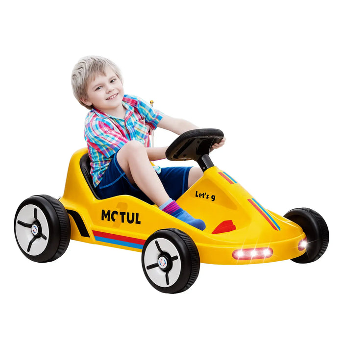 Child sitting in a yellow toy car with visible branding on a white background