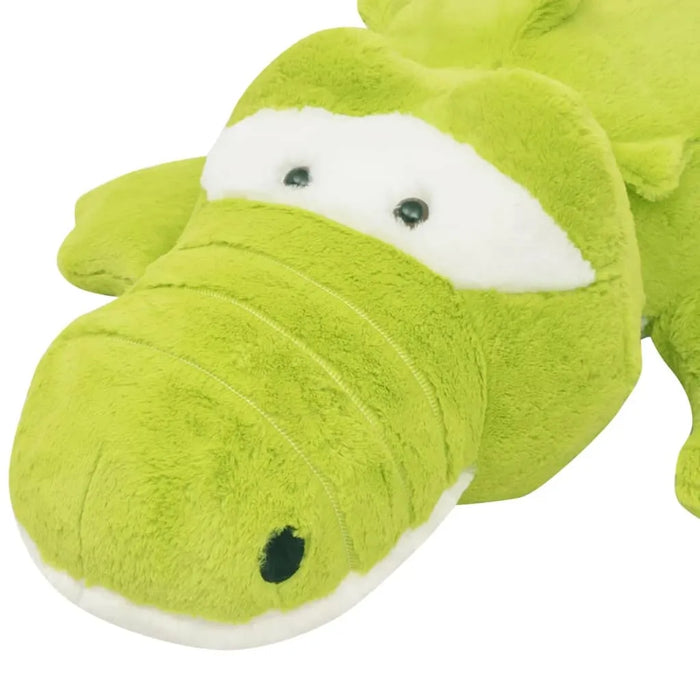Green plush alligator toy on a white background