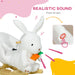 White plush dragon with a carrot, featuring realistic sound feature on a colorful background.