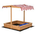 Yellow wooden sandbox with red striped adjustable canopy and blue storage bins