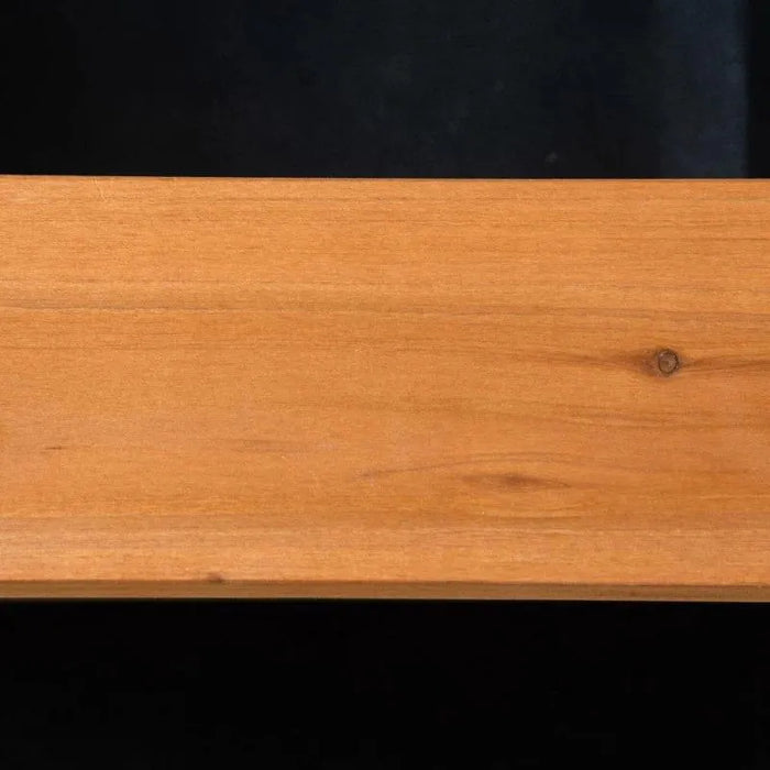 Close-up of smooth yellow wooden plank with visible grain and knot detail.