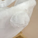 Close-up of white fluffy fabric on a beige background