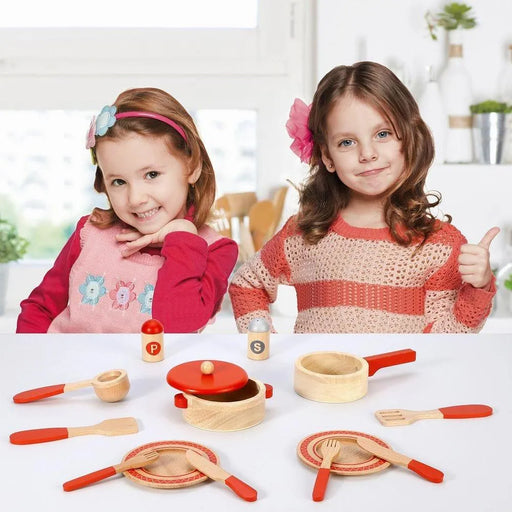 Two children with a 14-piece wooden cooking set, toy pots, pans, utensils on a table